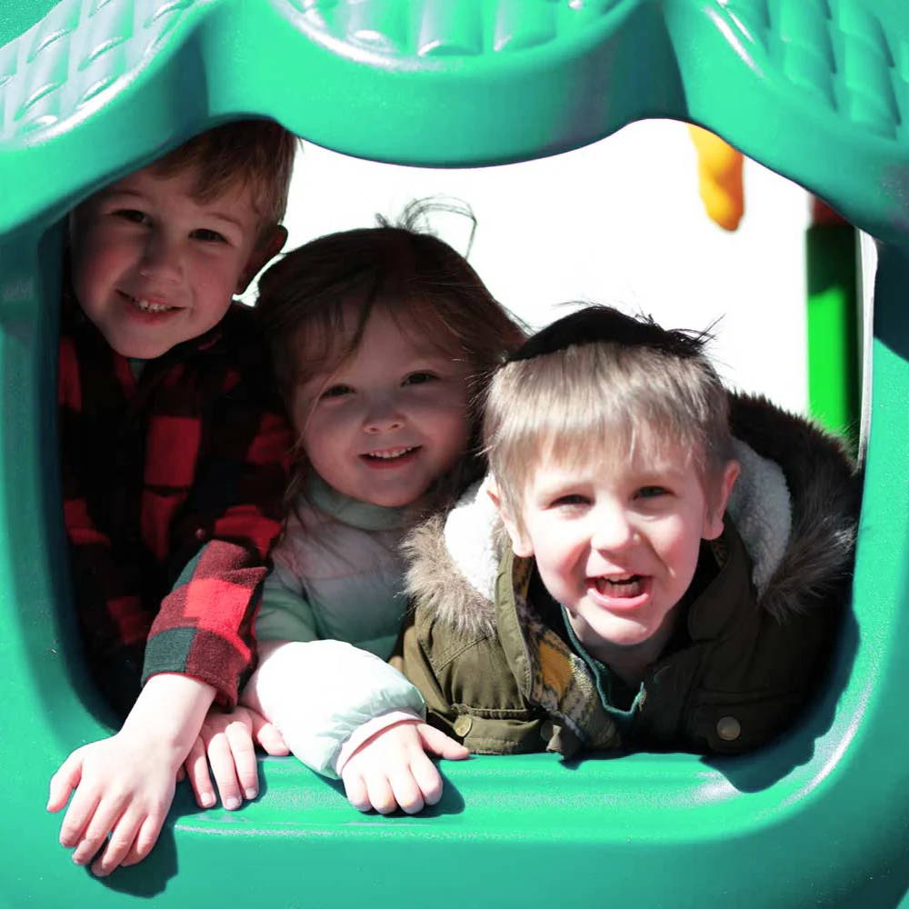 a group of children smiling at the camera